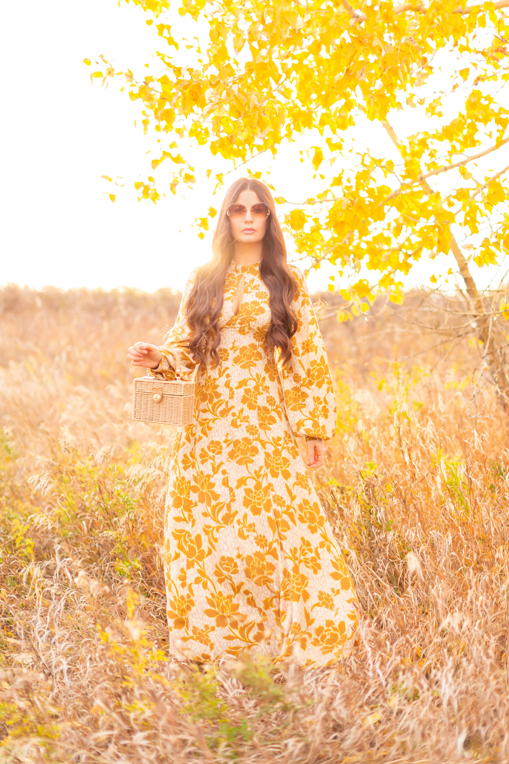 6 Luxe Bohemian Fall Outfits | Autumnal Ochre | Brunette woman wearing a fall floral printed ochre gown with long sleeves and oversized ombre retro inspired sunglasses amongst golden grasses and yellow leaves | | Boho Fall 2022 Outfit Ideas | Classic Fall Outfit Formulas | Feminine Bohemian Style | Polished Bohemian Style | Elegant Bohemian Style | Bohemian Outfit Ideas | Calgary Alberta Fashion Blogger // JustineCelina.com