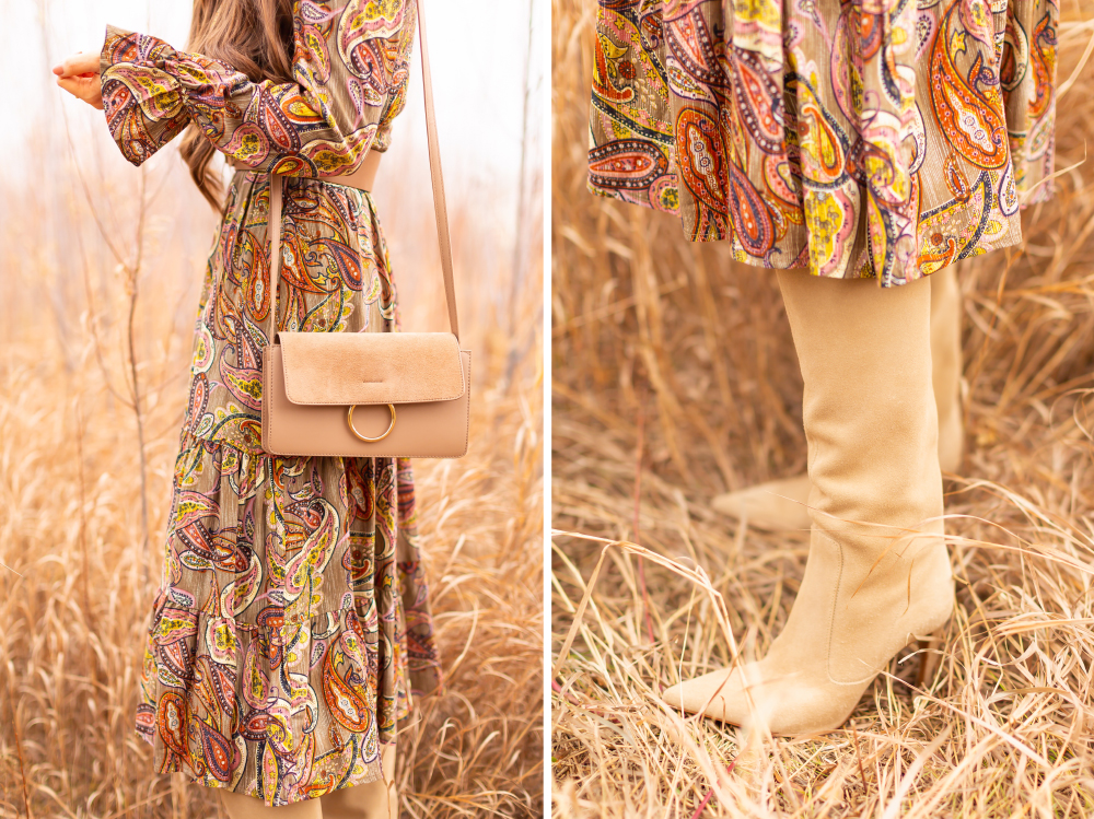 6 Luxe Bohemian Fall Outfits | Organic Olive | Brunette woman wearing an olive paisley maxi dress, taupe corset belt, taupe suede crossbody bag and taupe suede knee high boots amongst wild fall grasses in a willow grove | Boho Fall 2022 Outfit Ideas | Feminine Bohemian Style | Polished Bohemian Style | Elegant Bohemian Style | Bohemian Outfit Ideas | How to Style a Paisley Maxi Dress for Fall | Calgary Alberta Fashion Blogger // JustineCelina.com