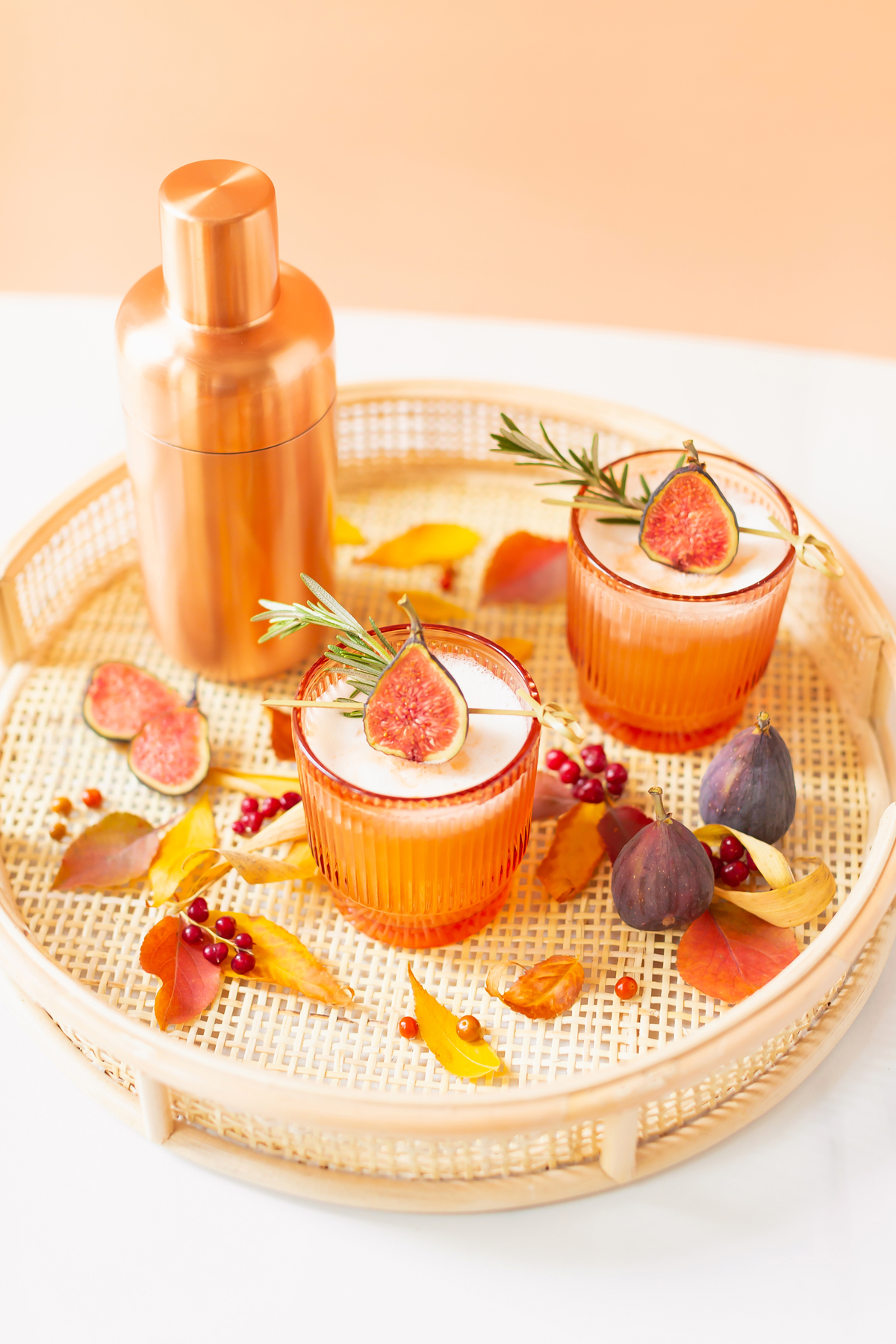 5 Cozy Fall Cocktail and Sangria Recipes | JustineCelina’s Best Fall Cocktail and Sangria Recipes | Rosemary Fig Japanese Whisky Sour | A Whisky Sour Cocktail with a Fresh Fig Garnish on a Rattan Serving Tray with Autumn Leaves and a Brass Cocktail Shaker in the Background | Autumn Whiskey Cocktails | Best Fall Whisky Cocktail Recipes | Fall Fig Cocktail | Japanese Whisky Cocktail | Nikka Super Rare Old Cocktail | Calgary Cocktail Photographer and Stylist | Calgary Blogger // JustineCelina.com